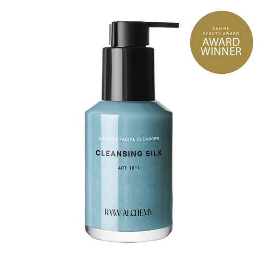 RAAW Alchemy Cleansing Silk - Danish Beauty Award winner calming facial cleanser in a signature blue glass bottle.