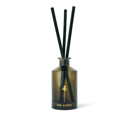 RAAW Alchemy Minted Fig Room Diffuser in a signature green glass bottle with natural reeds.