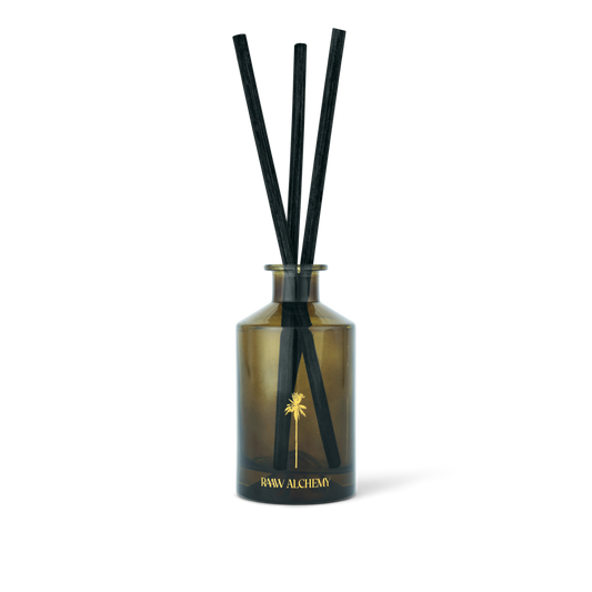 RAAW Alchemy Minted Fig Room Diffuser in a signature green glass bottle with natural reeds.