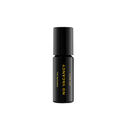 RAAW Alchemy Petit Sauvage perfume oil rollerball in a travel-friendly black glass bottle with gold branding.