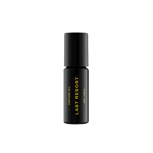 RAAW Alchemy Last Resort perfume oil rollerball, a clean and sophisticated scent in a compact black glass bottle.