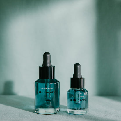 Two sizes of RAAW Alchemy Blue Drops calming face oil displayed in a clean, aesthetic lighting.